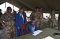 The Head of AU Verification Team (seated) signing the relevant documents after a tour of the facilities.